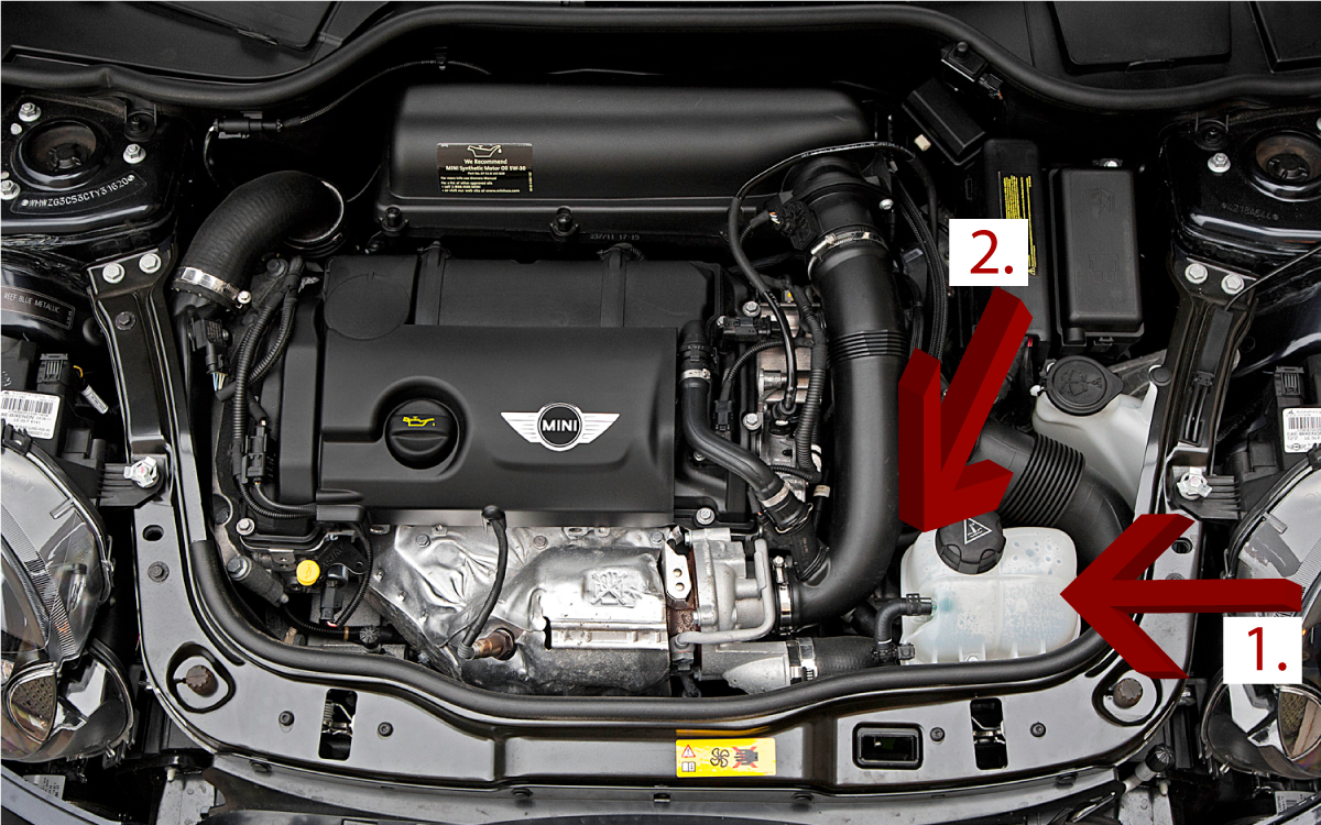 Mini Cooper Engine Compartment with Arrows Showing Coolant Reservoir Tank and Oil Filter General Location